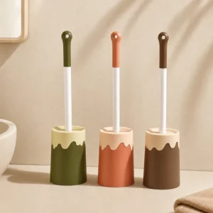 Decorative toilet brush holders displayed beside a bathroom toilet