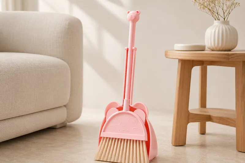 Pink kids broom and dustpan set showing handle bristles and rounded edges