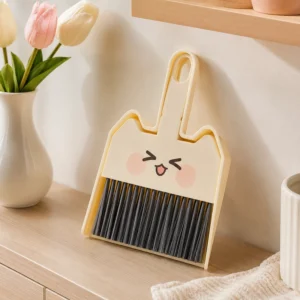 Front view of cute desktop dustpan brush set with dark bristles