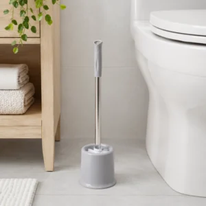 Light gray toilet brush holder beside toilet in bathroom