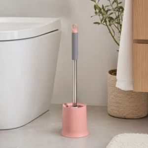 Pink soft handle toilet brush with freestanding bathroom holder beside toilet