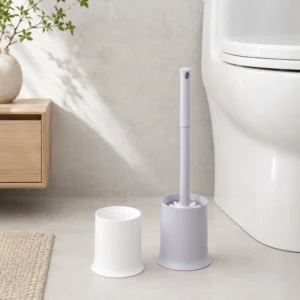 Minimalist toilet brush with holder beside toilet